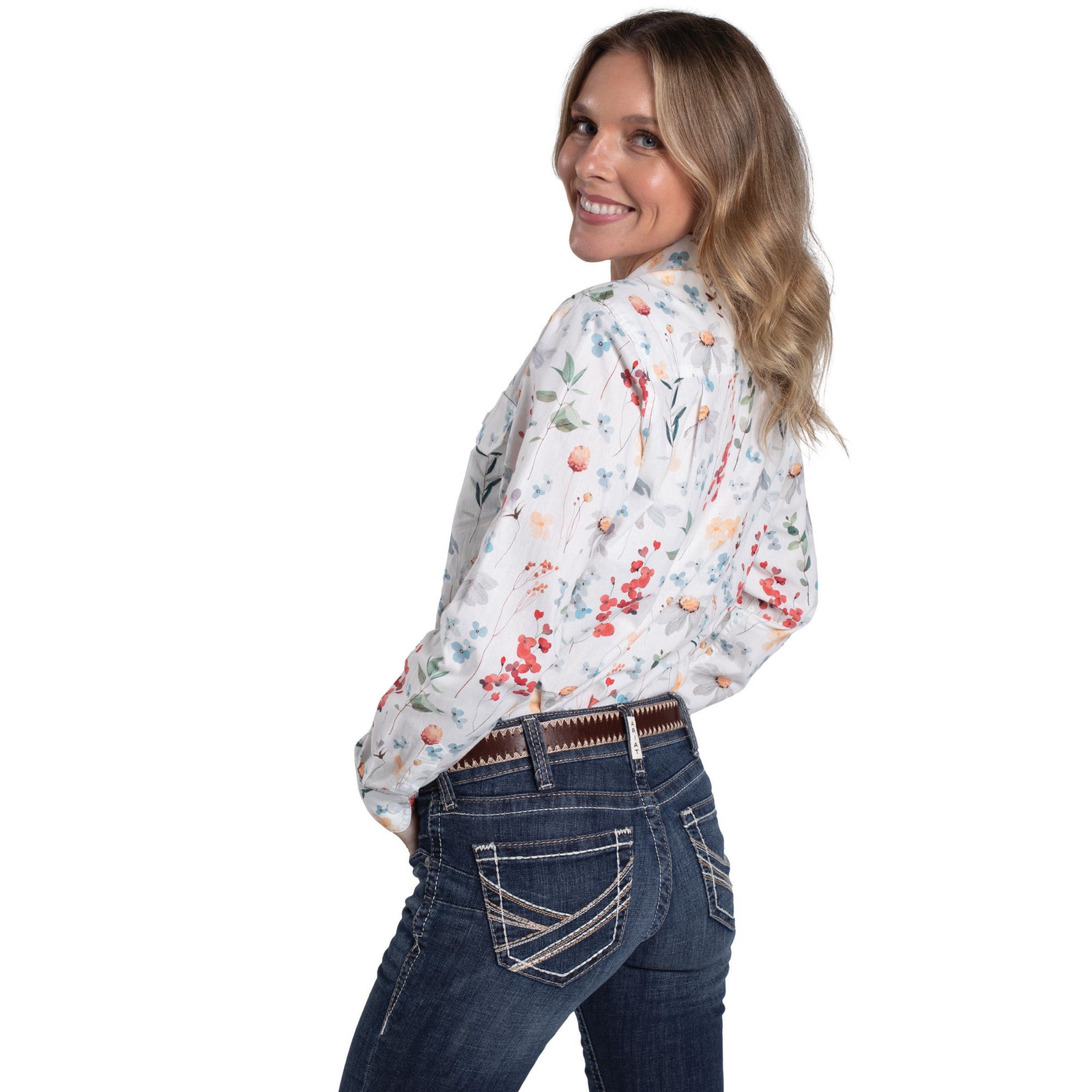 Woman wearing a floral blouse and jeans on a white background