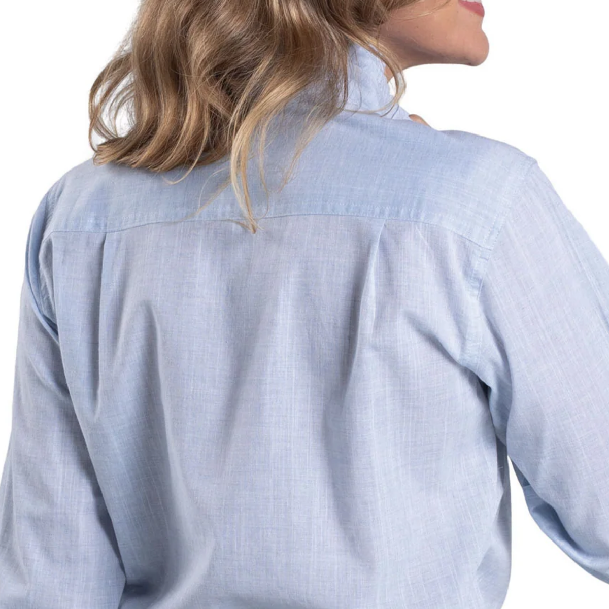 Light blue denim shirt worn by a person on a white background
