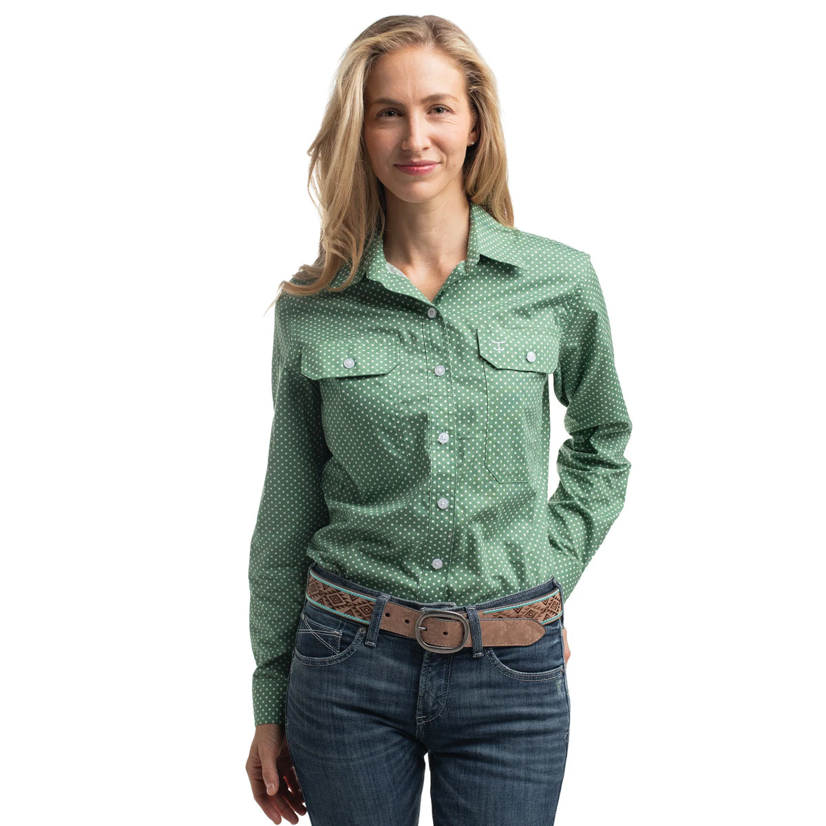 Woman wearing a green patterned shirt and blue jeans on a white background