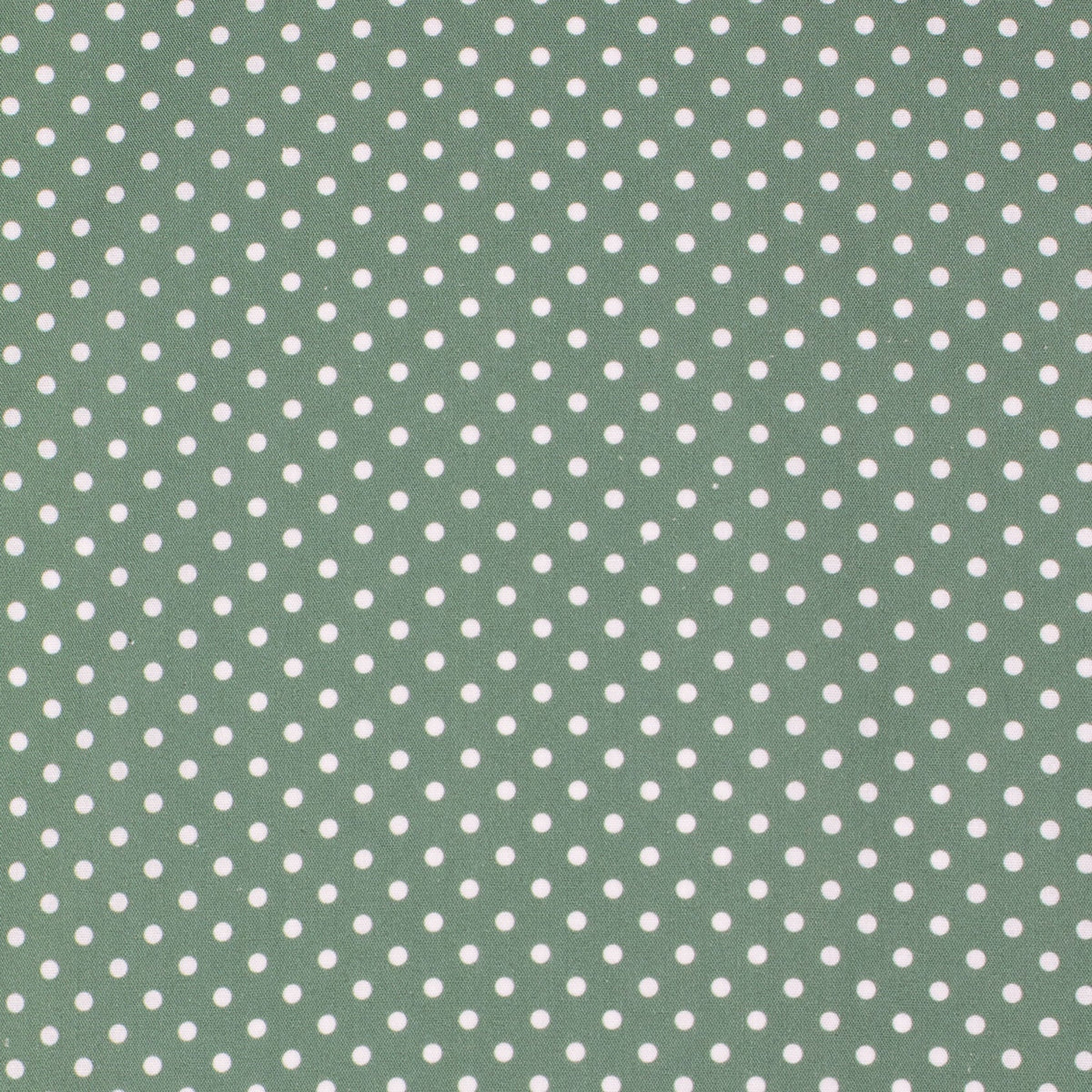 Green fabric with white polka dot pattern