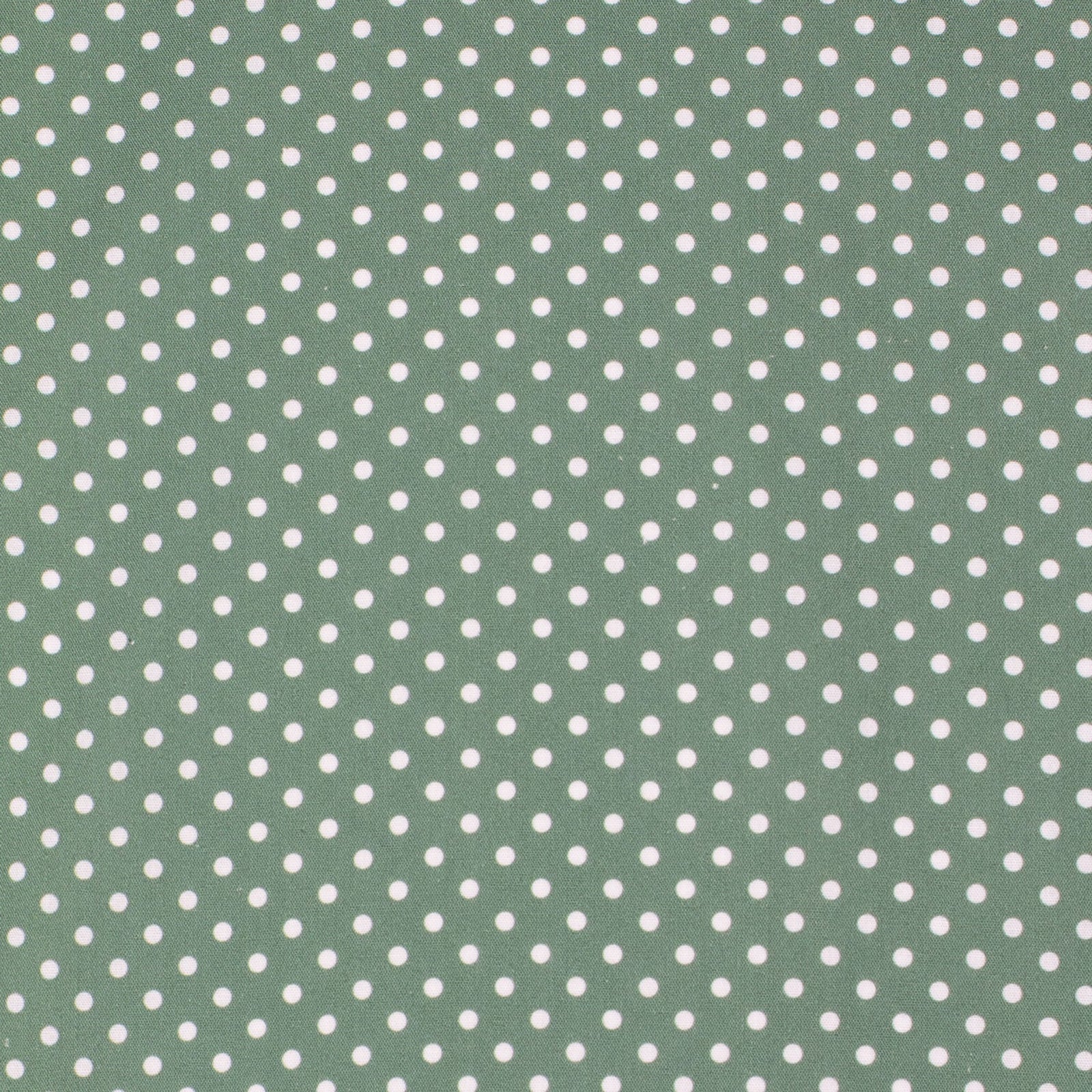 Green fabric with white polka dot pattern