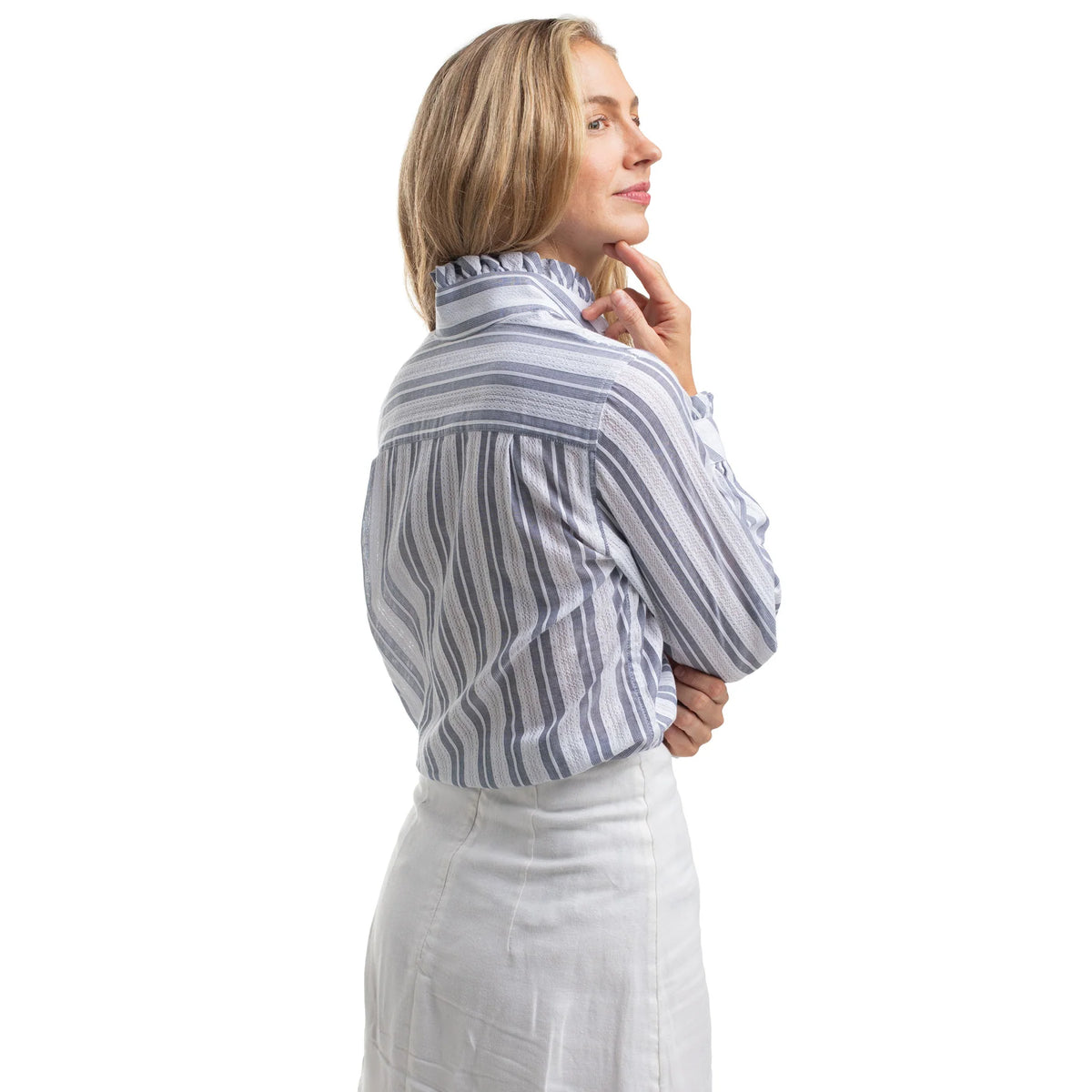 Woman wearing a striped shirt and white pants on a white background
