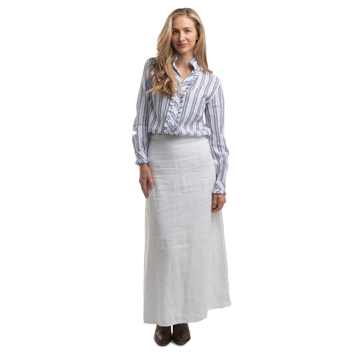 Woman wearing a striped shirt and long white skirt on a white background
