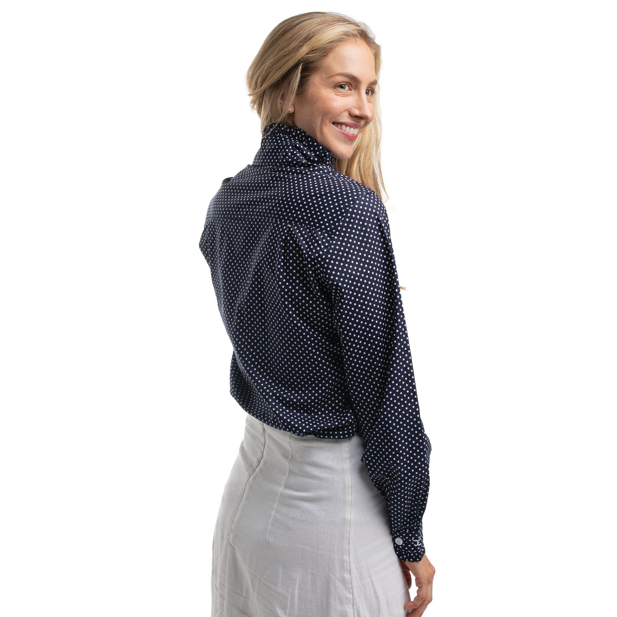 Woman wearing a navy blue patterned blouse on a white background