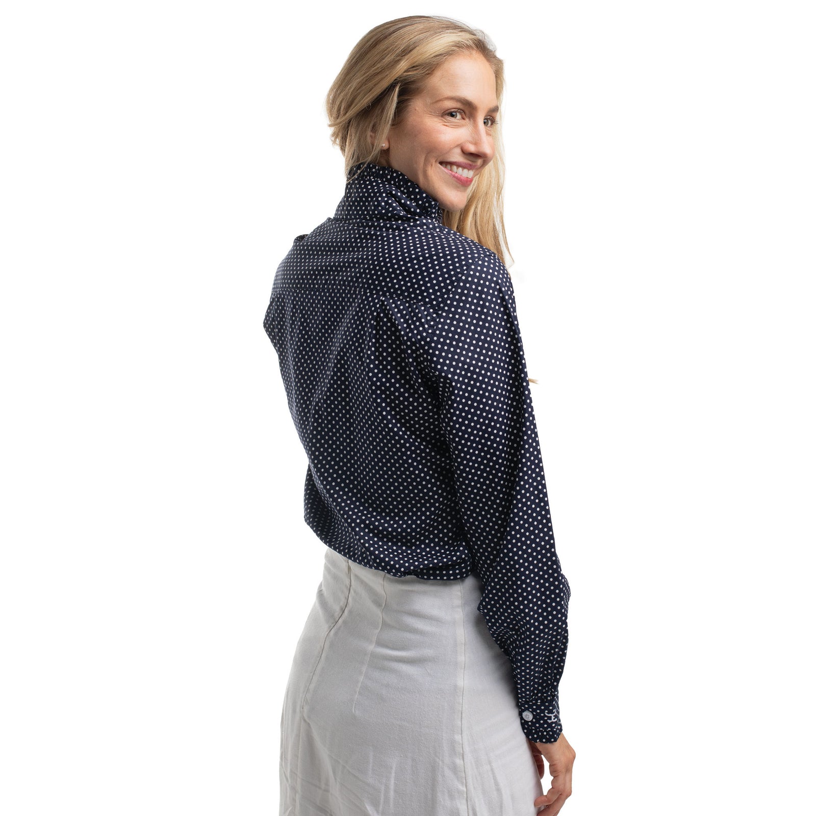 Woman wearing a navy blue patterned blouse on a white background