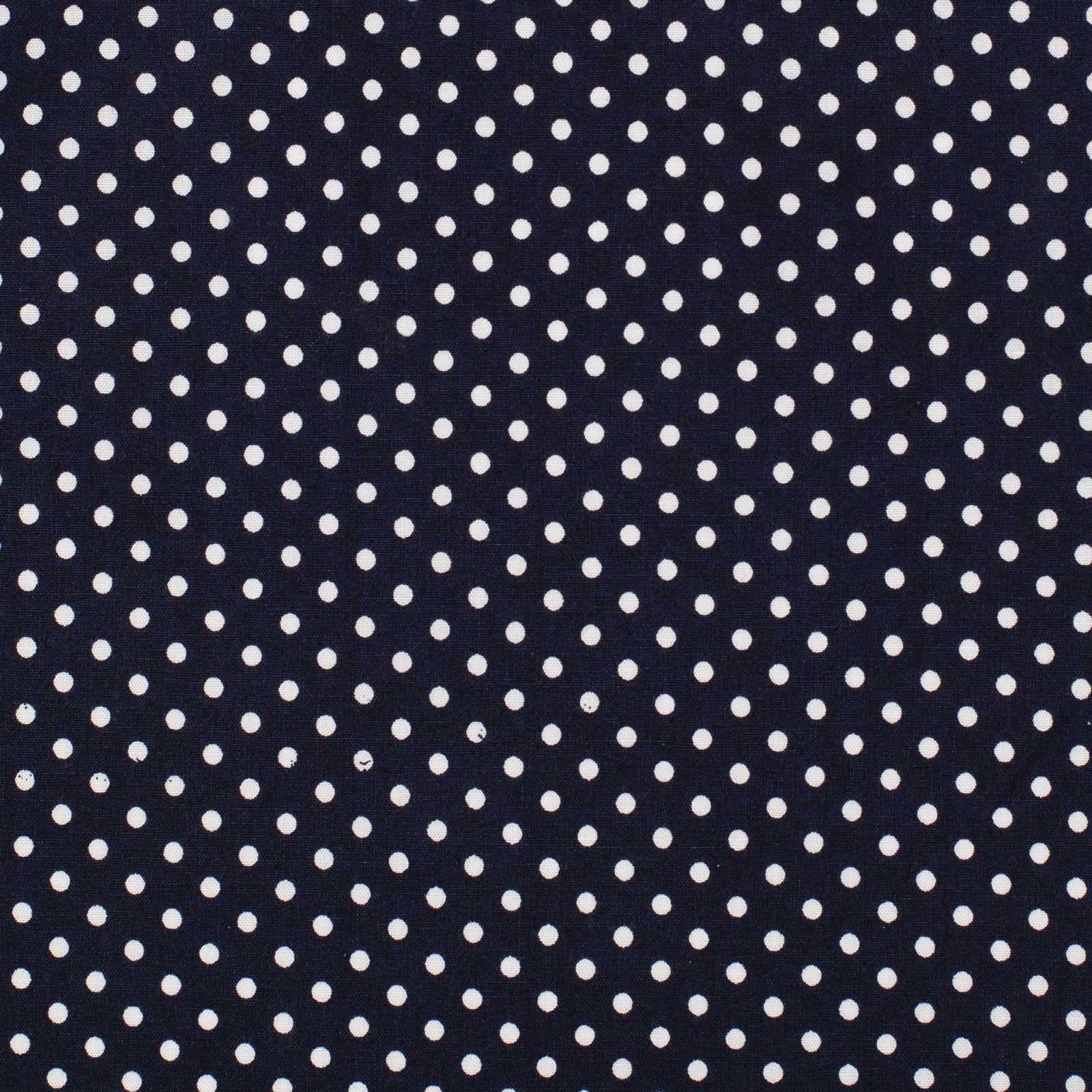 A close-up of a fabric pattern featuring small white polka dots on a dark navy blue background.