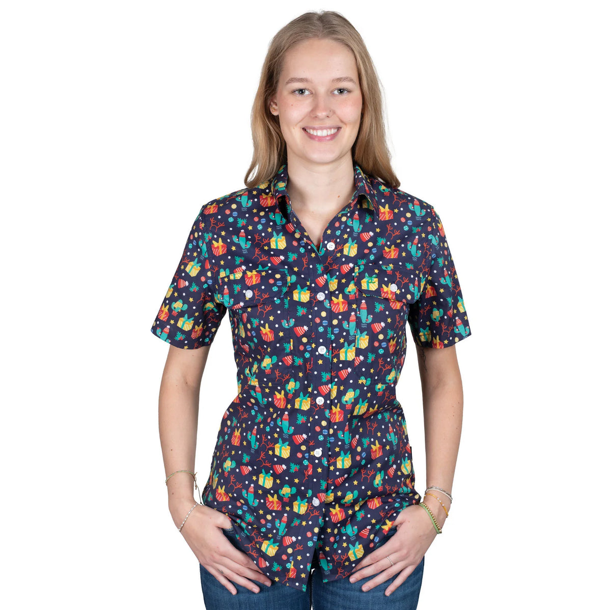 Just Country Women&#39;sIzzy Full Button Print Short Sleeve Christmas Shirt. Woman wearing a colorful patterned shirt on a white background