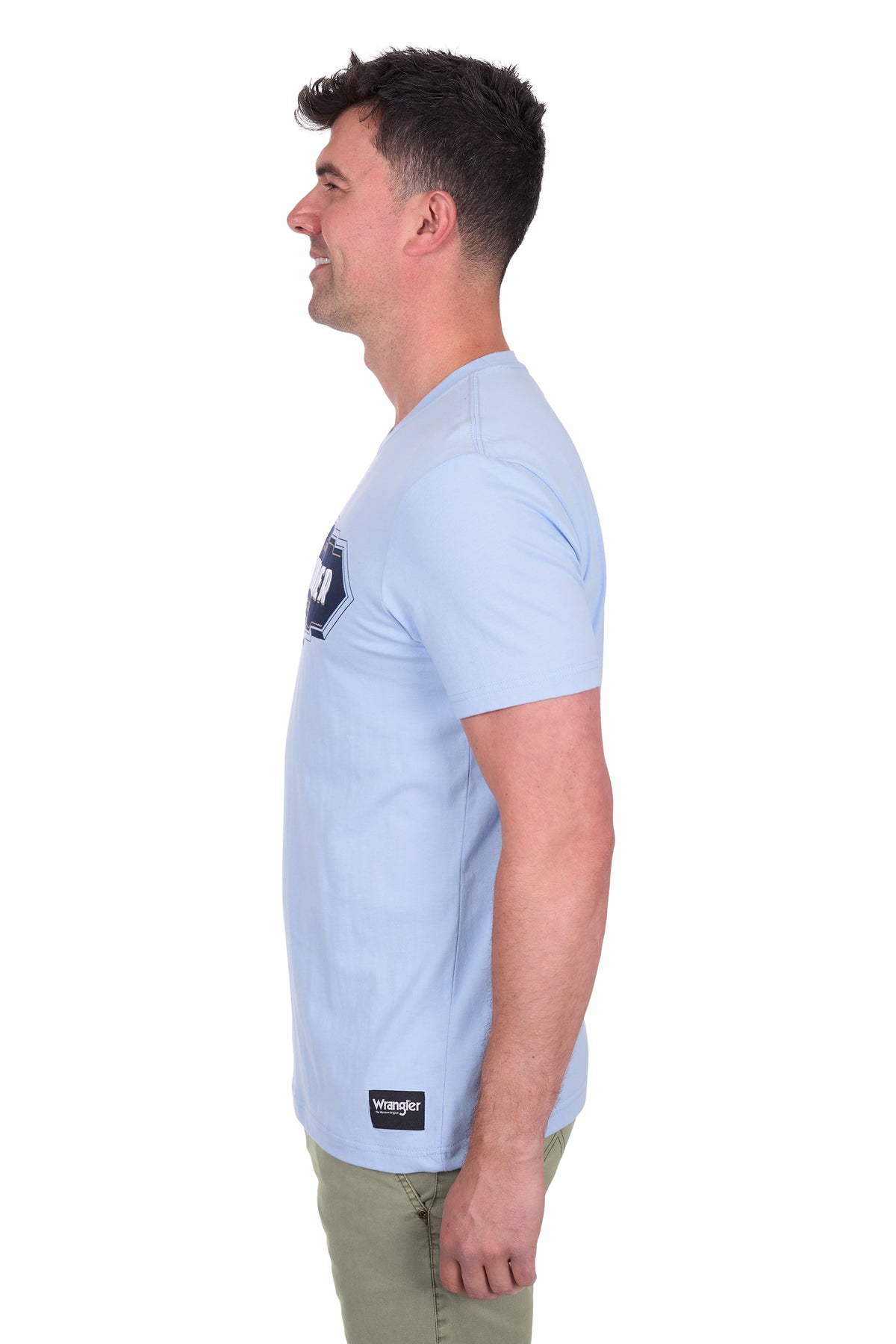 Wrangler Men's Roy S/S T-Shirt. Man wearing a light blue t-shirt with a logo on a white background