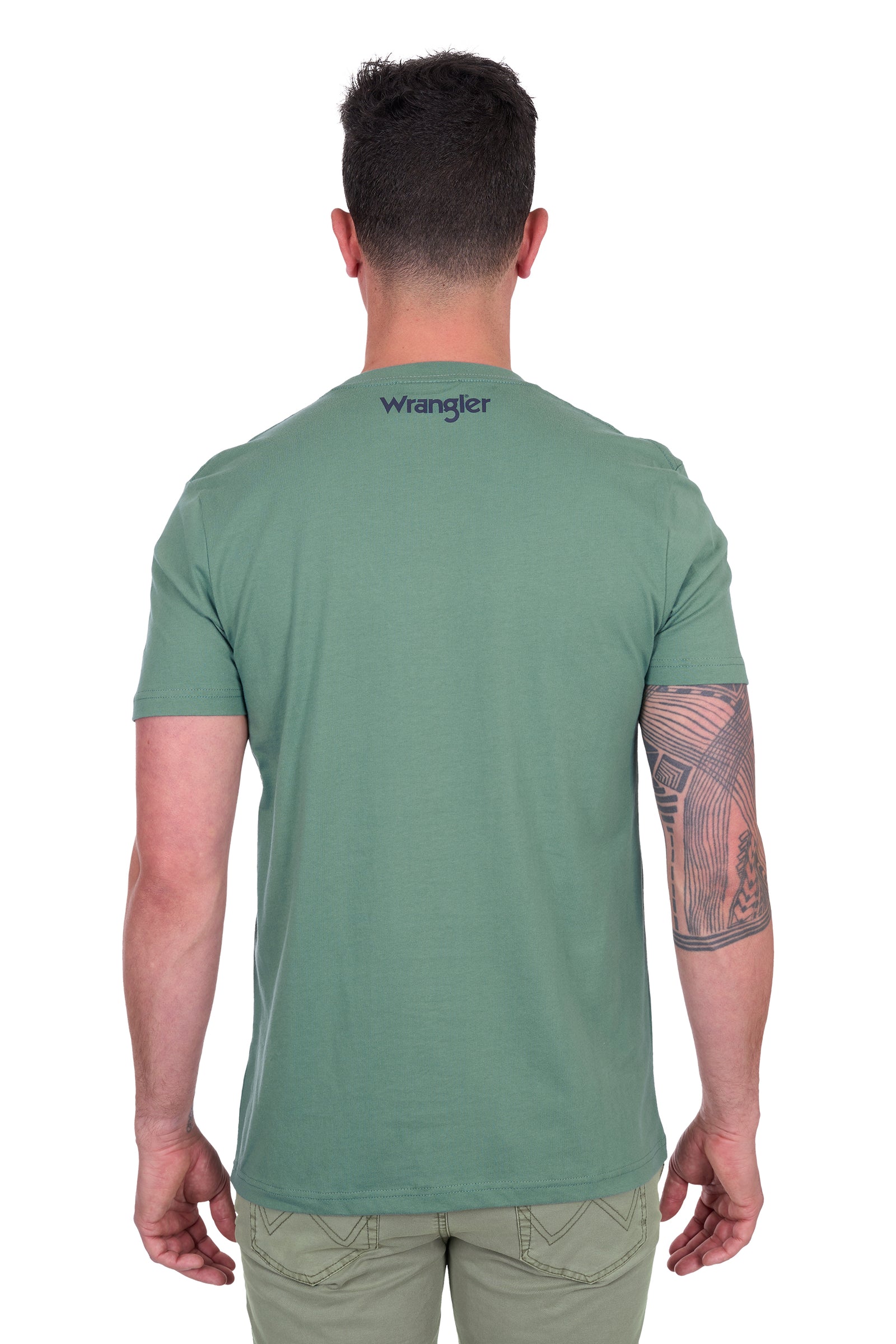 Wrangler Men's Arthur S/S T-Shirt. Man wearing a green t-shirt with 'Wrangler' logo on the back, standing against a white background.