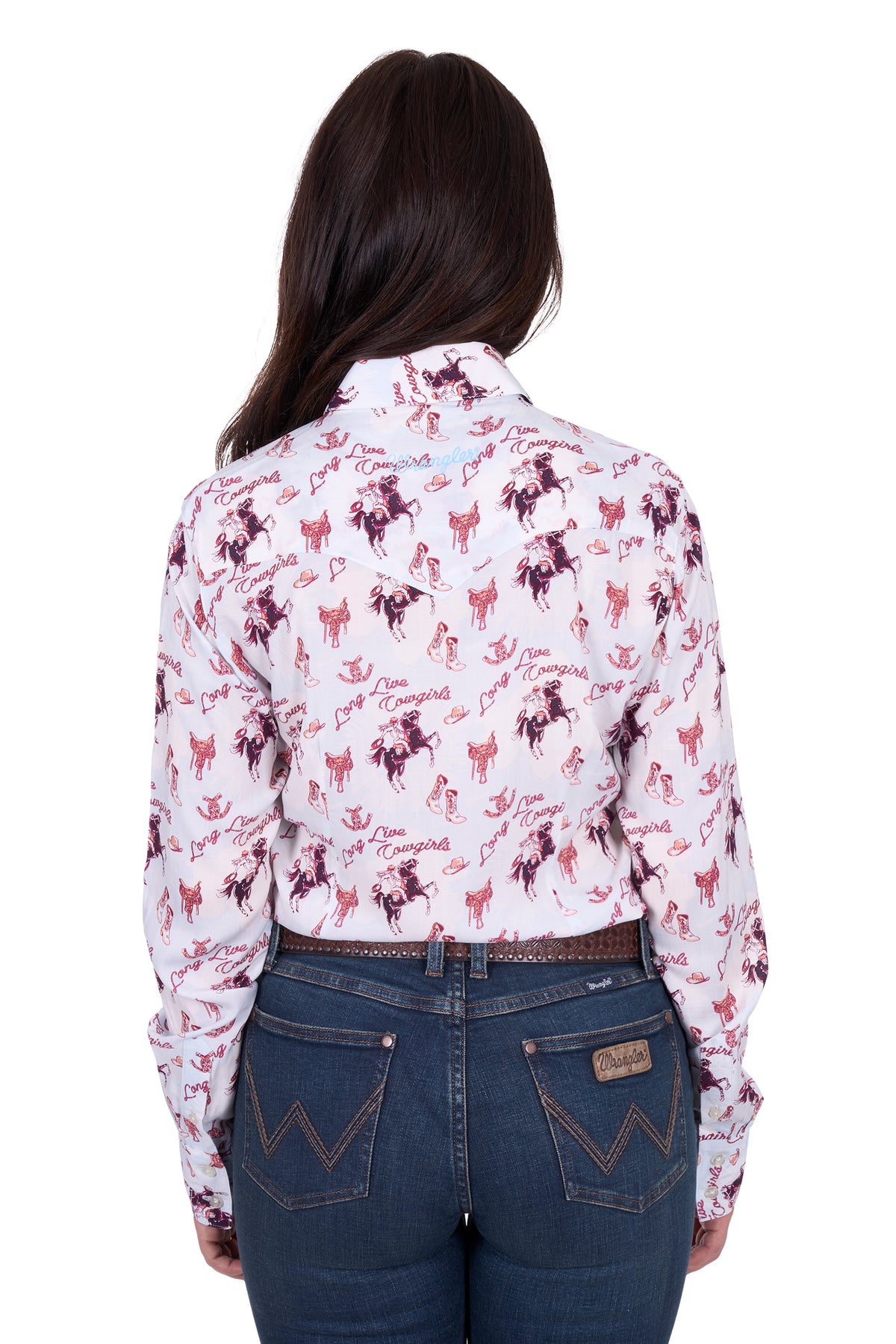 Wrangler Women's Doreen L/S Western Shirt. Woman wearing a white shirt with pink floral patterns and blue jeans on a white background