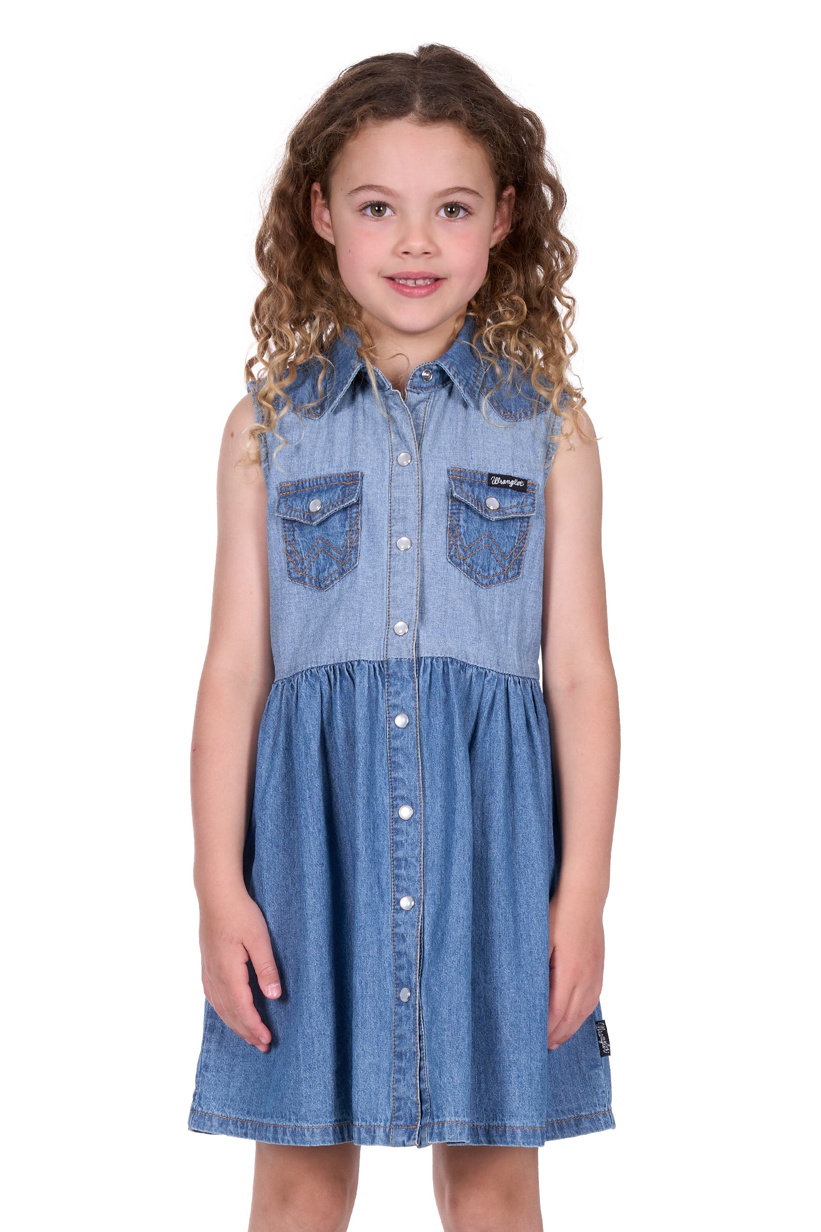 Wrangler Girl's Joanna Sleeveless Dress. Young girl wearing a denim dress with a white background