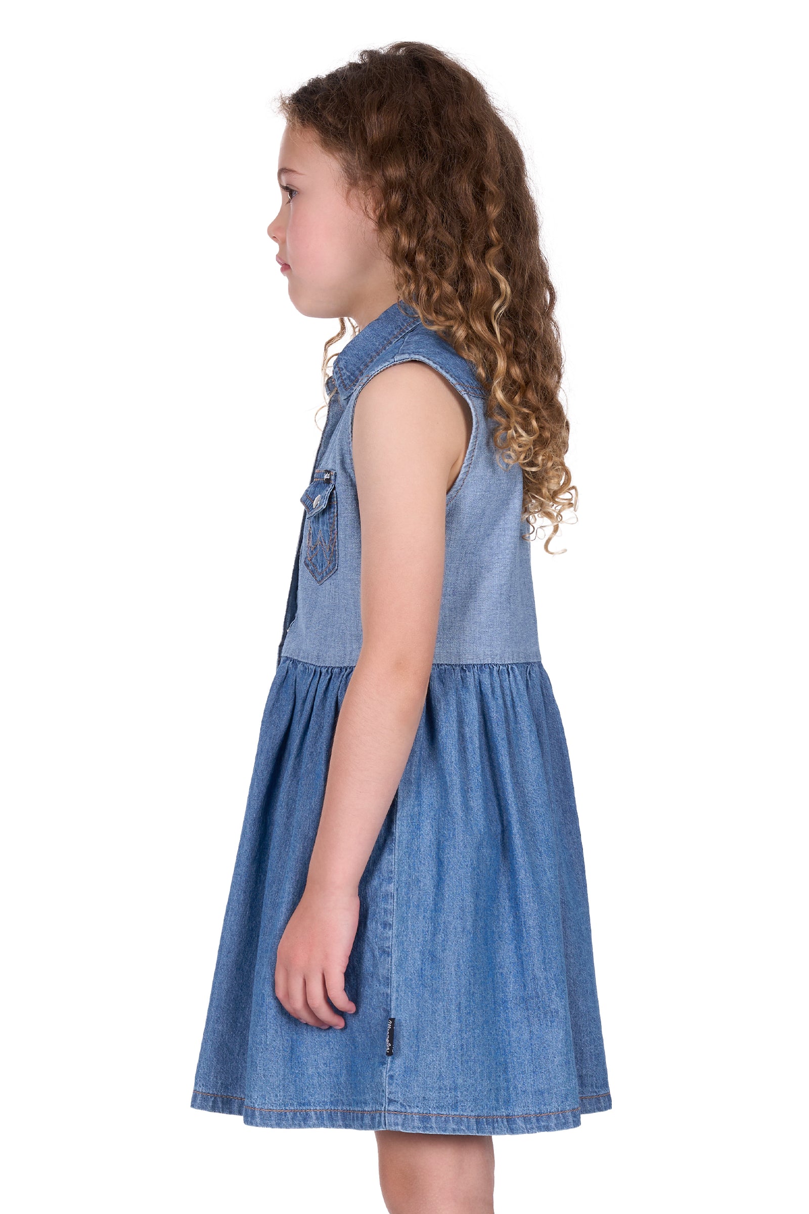 Wrangler Girl's Joanna Sleeveless Dress. Young girl wearing a denim dress with a white background