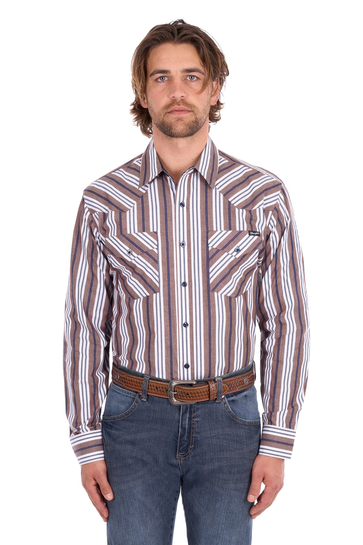 A man wearing a long-sleeve western-style button-up shirt with vertical brown, beige, and white stripes, paired with blue jeans and a brown leather belt, against a plain white background.