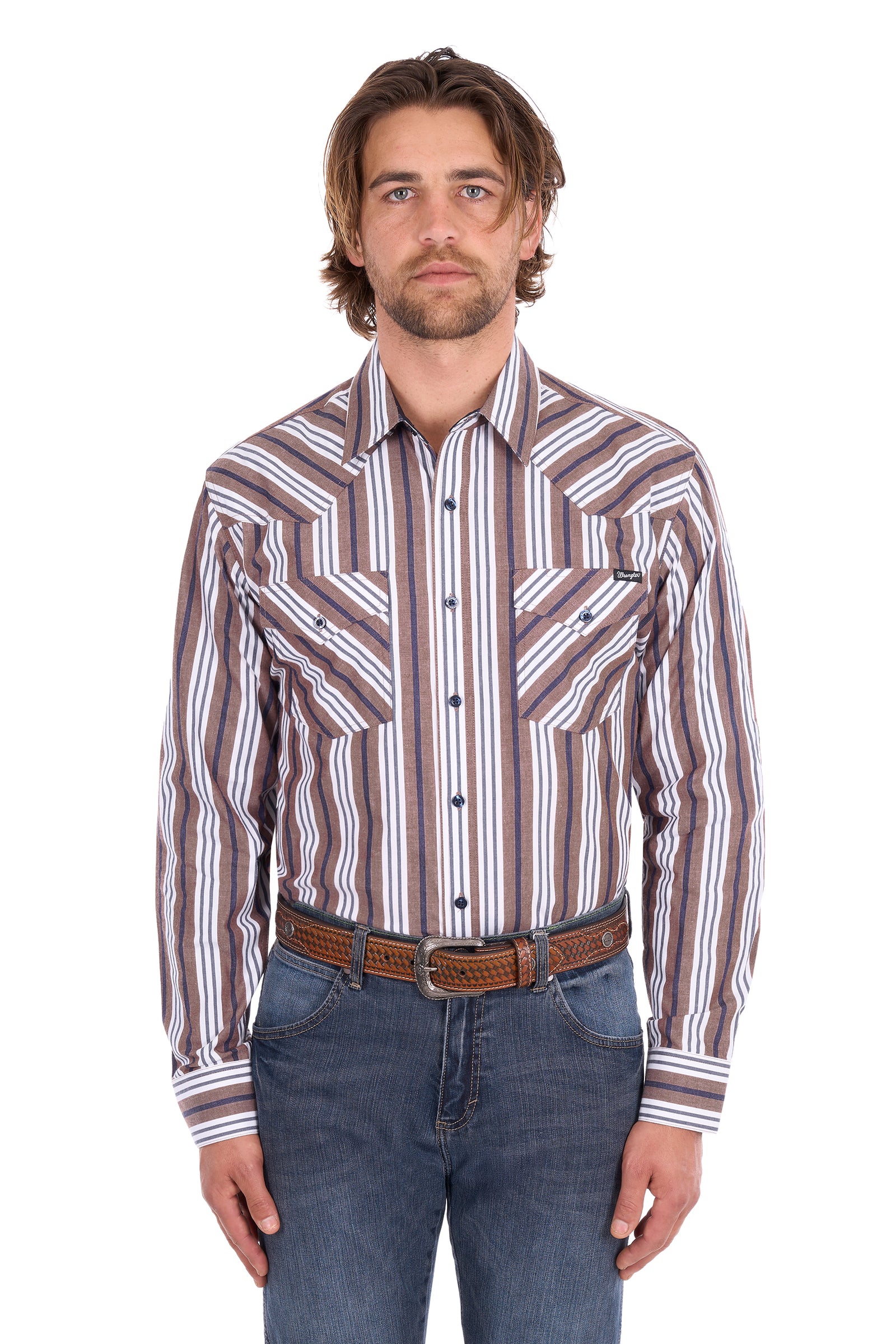 A man wearing a long-sleeve western-style button-up shirt with vertical brown, beige, and white stripes, paired with blue jeans and a brown leather belt, against a plain white background.