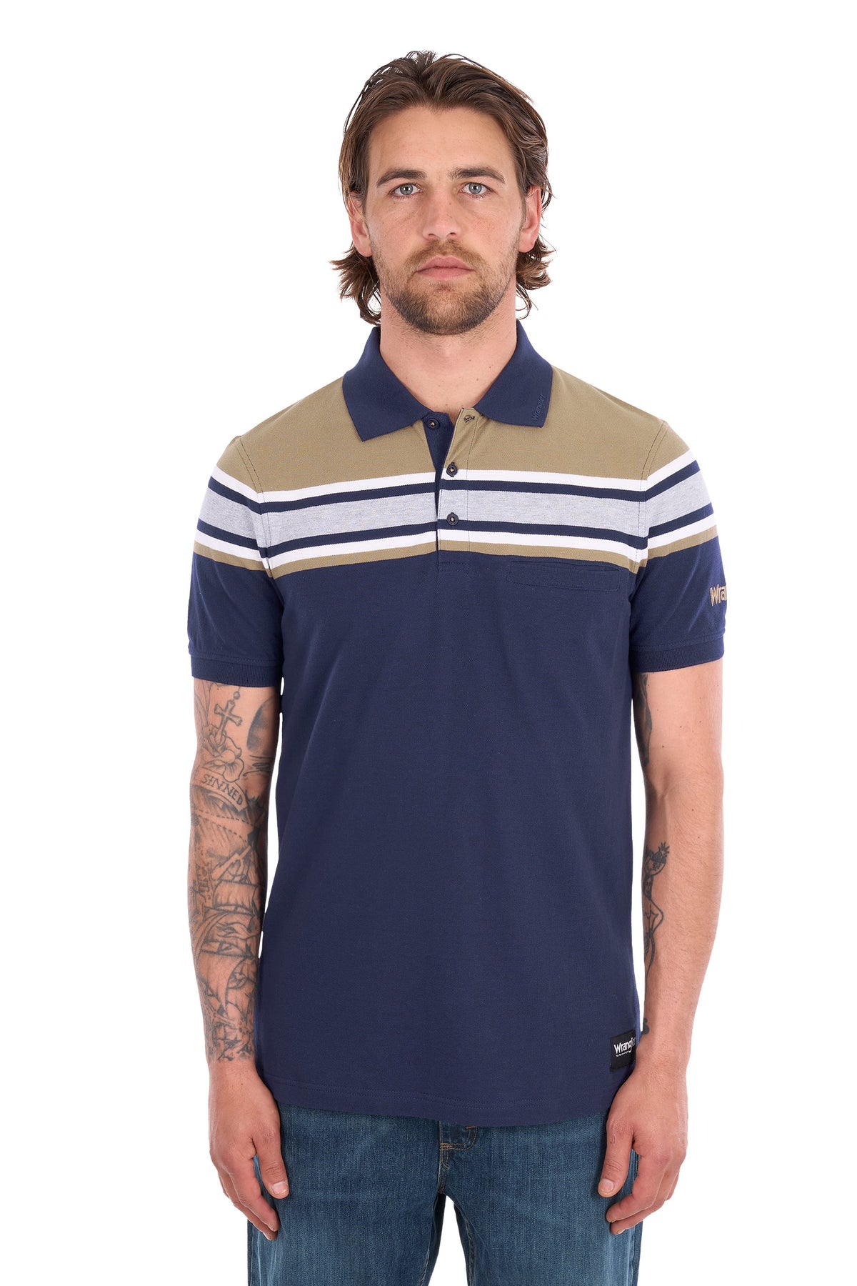 A man wearing a navy blue polo shirt with beige and white horizontal stripes across the chest and shoulders, paired with blue jeans, photographed against a plain white background.