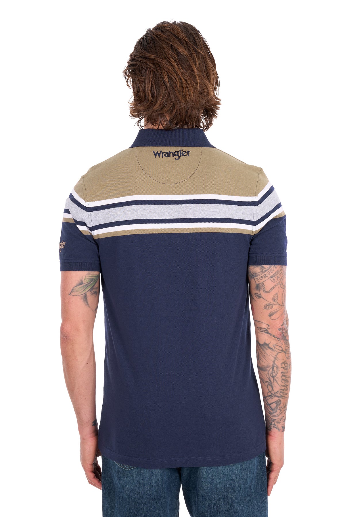 A man viewed from the back wearing a Wrangler short-sleeve polo shirt. The shirt features a navy blue body with a beige yoke and horizontal stripes in white and navy across the shoulders and upper back.