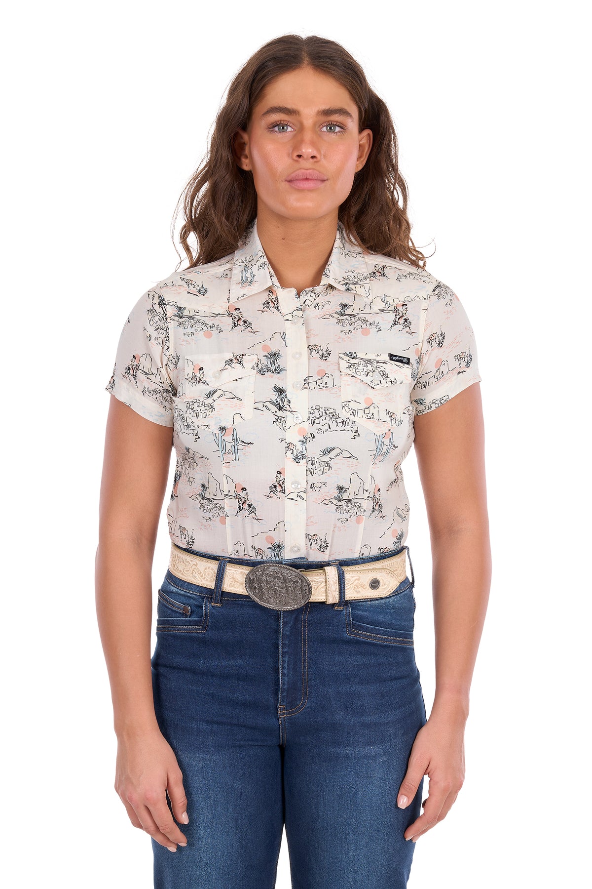 A woman modeling a short-sleeve western-style button-up shirt with a beige and brown floral print, paired with blue jeans and a western belt, against a plain white background.