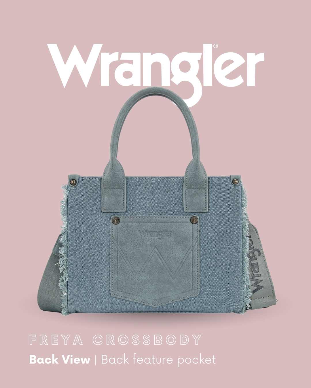 Wrangler Freya Crossbody handbag shown from the back on a dusty pink background, featuring a light blue denim body, frayed edges, double top handles, and a back feature pocket.