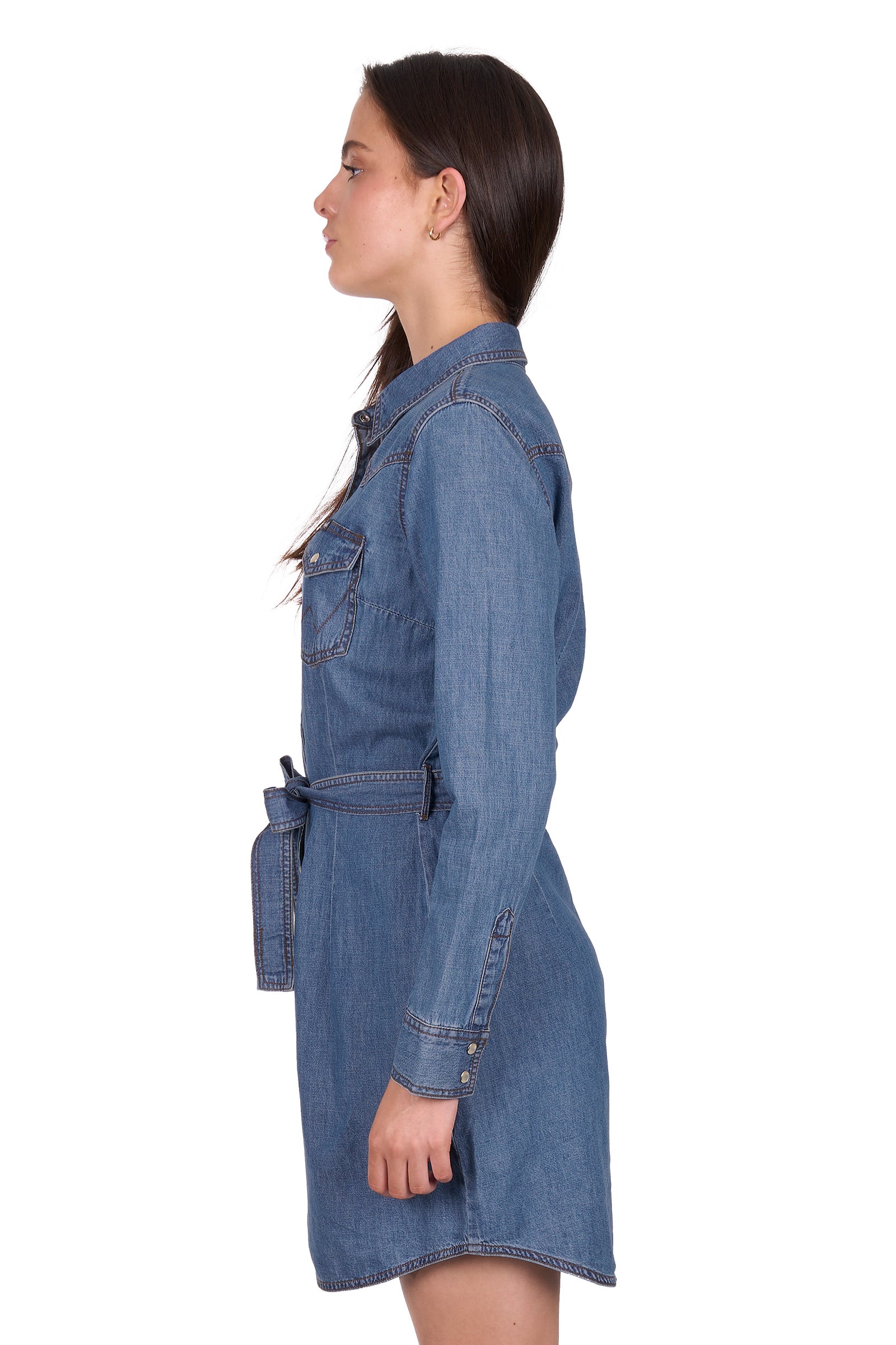 Woman wearing a blue denim dress on a white background