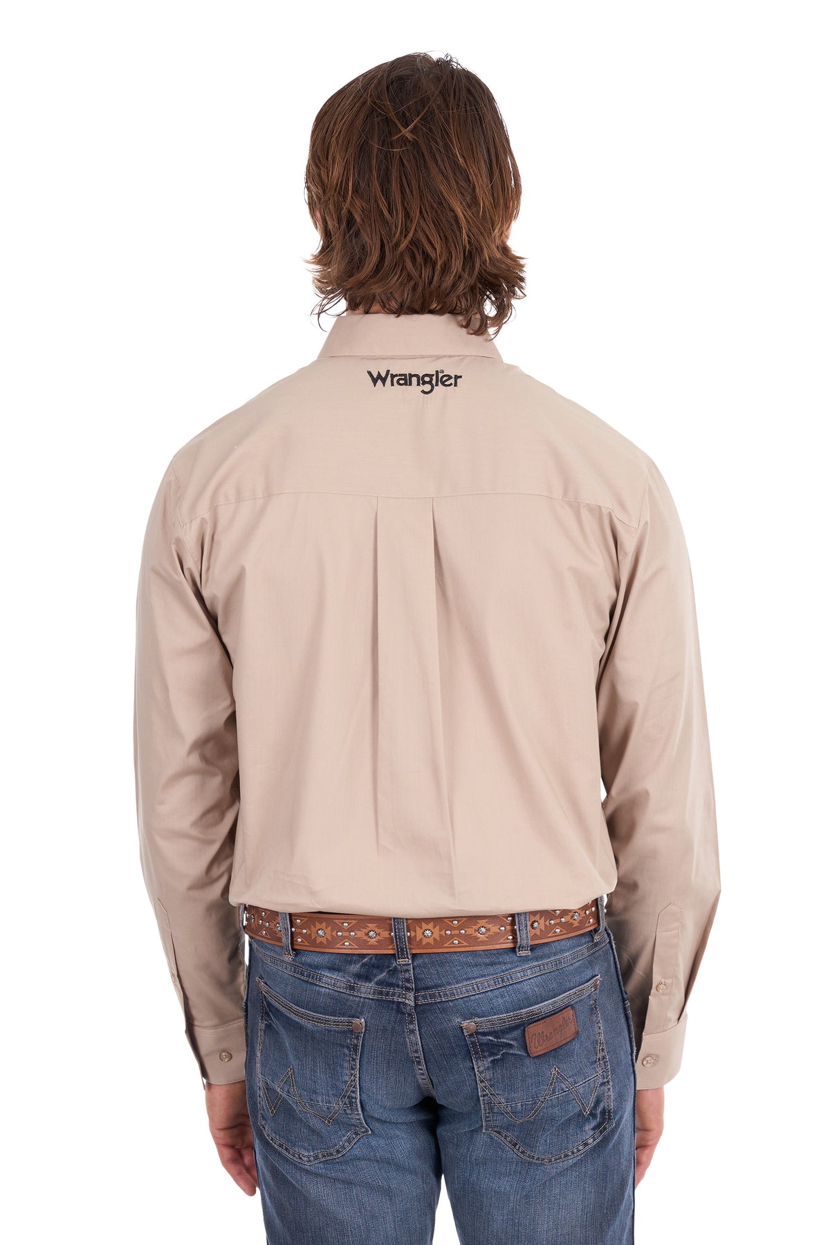 A man viewed from behind wearing a light beige Wrangler long-sleeve button-down shirt tucked into blue jeans with a brown patterned belt, against a plain white background.