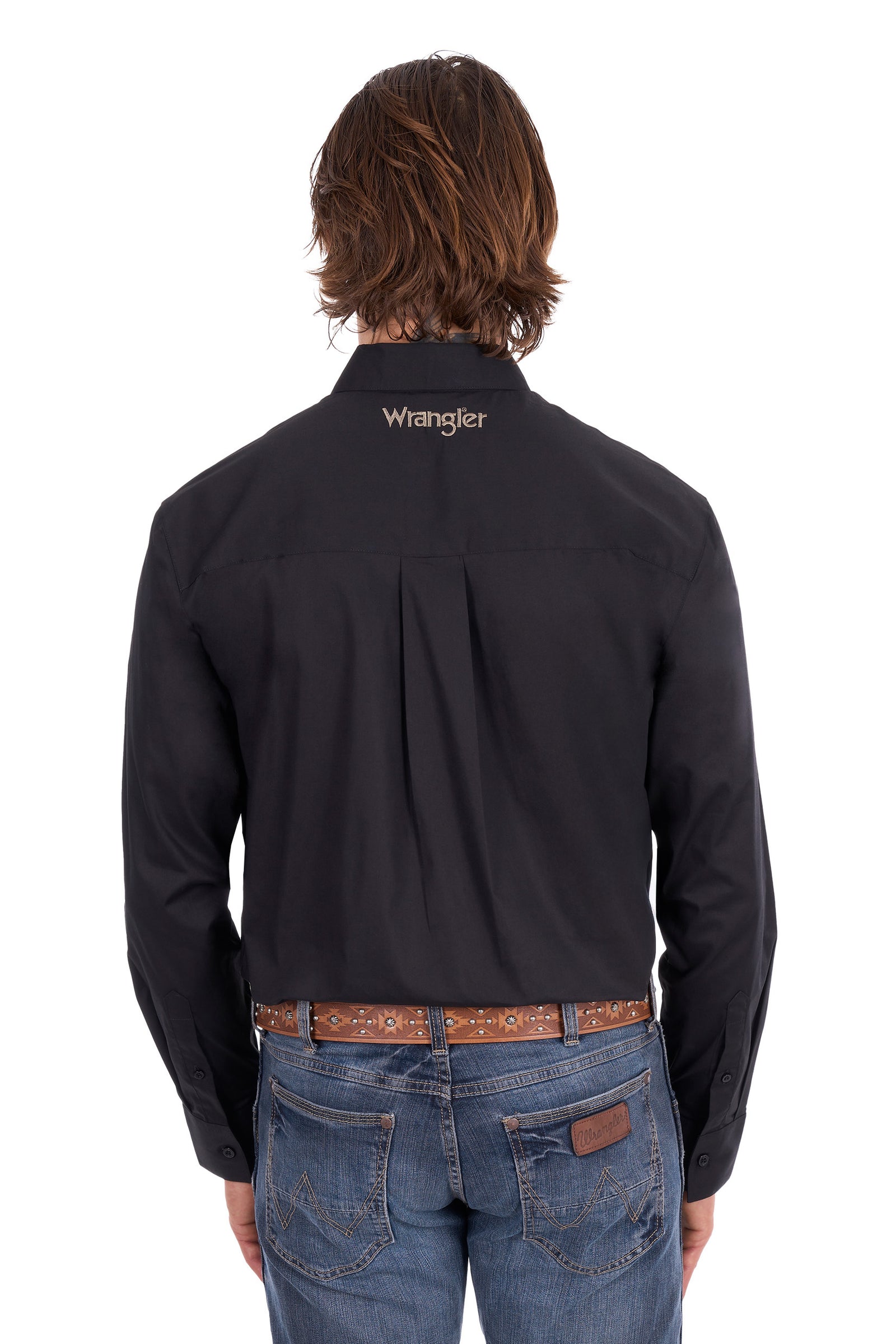 A man viewed from the back wearing a black Wrangler long-sleeve shirt tucked into blue jeans with a brown patterned belt, against a plain white background.
