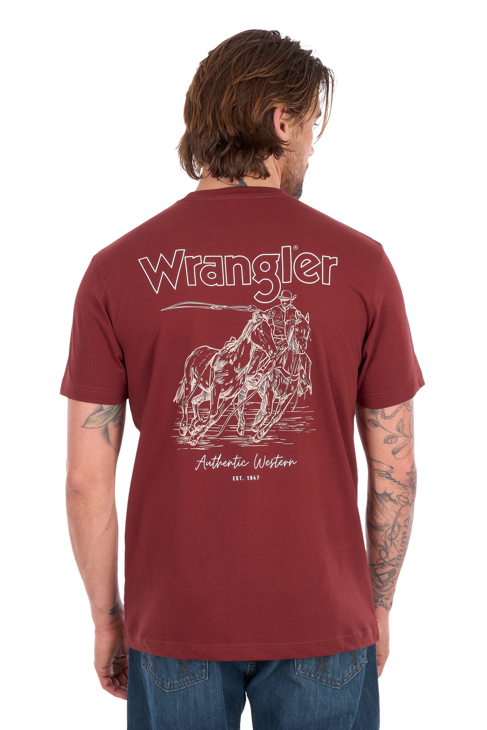 A man wearing a maroon Wrangler short-sleeve t-shirt and a blue trucker hat, standing against a white background.