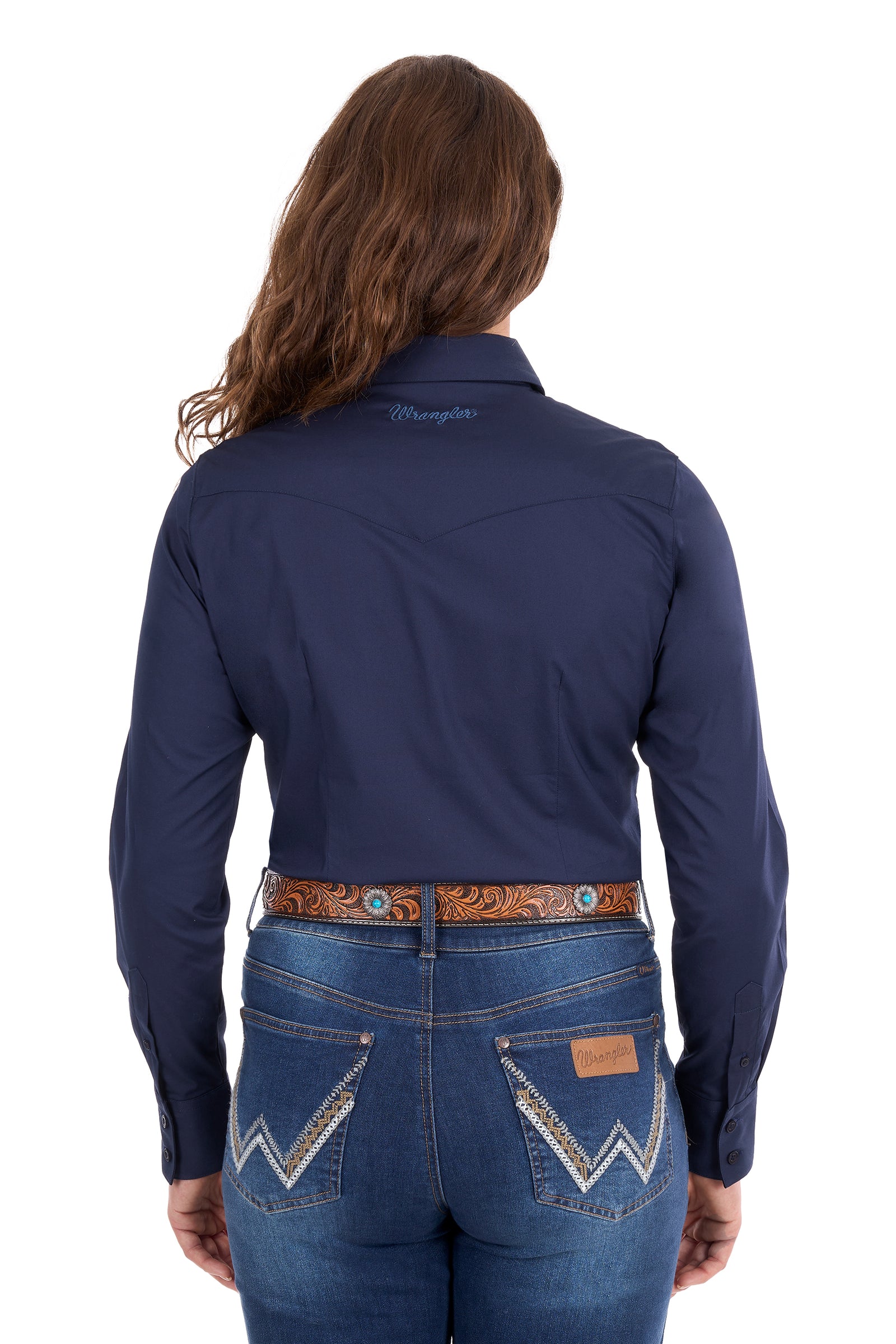 Rear view of a woman wearing a navy blue long-sleeve western shirt and blue jeans with western-style stitching, on a white background.