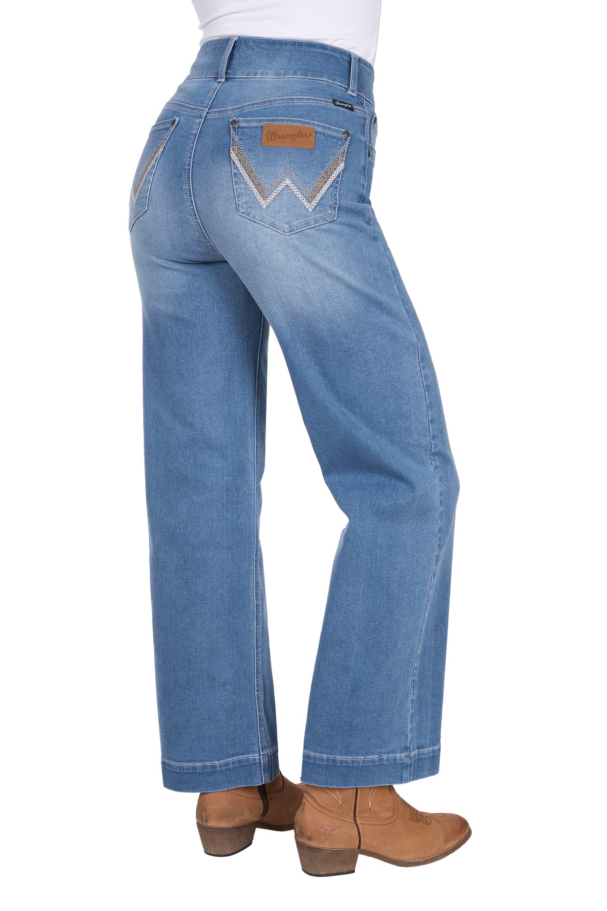 Blue jeans worn by a person on a white background