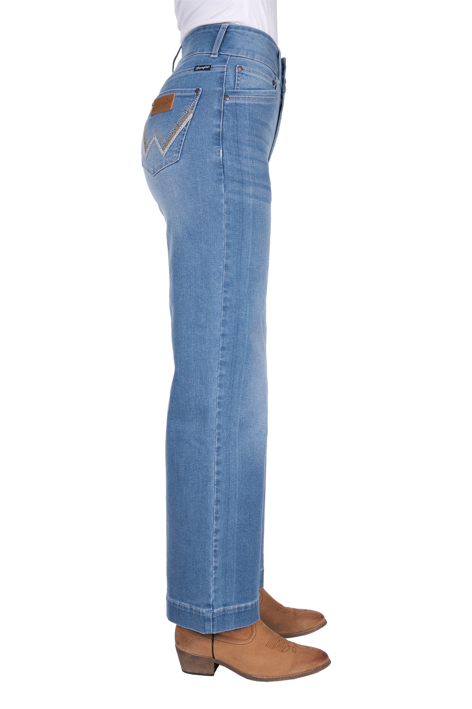 Blue jeans worn by a person on a white background