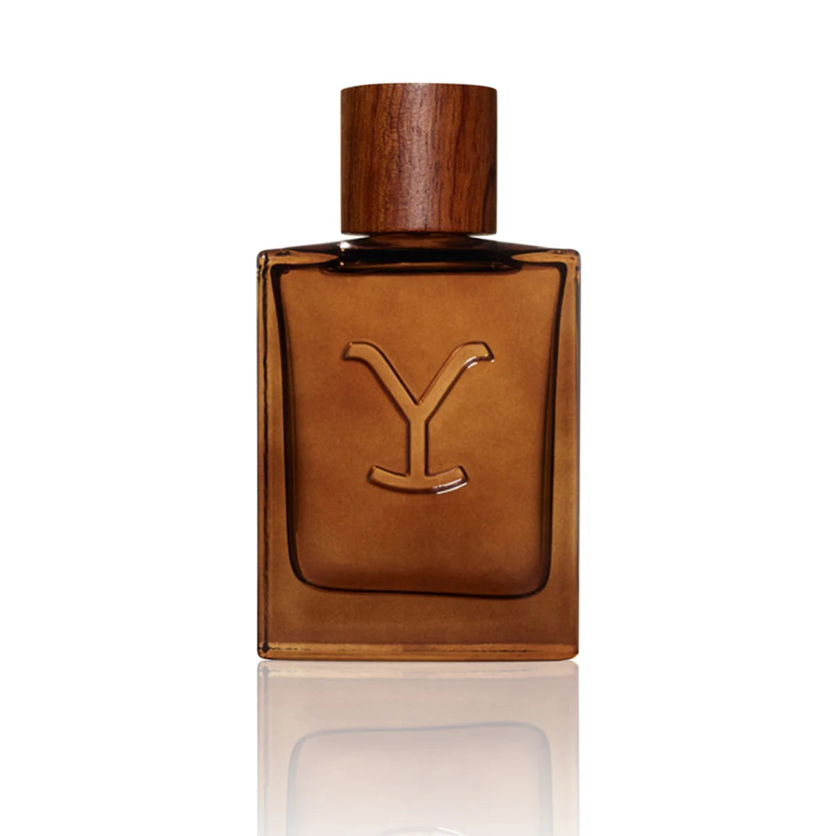 A rectangular amber-brown glass perfume bottle with a matching wooden cap and a large embossed letter Y on the front, centered on a white background with a soft reflection below.