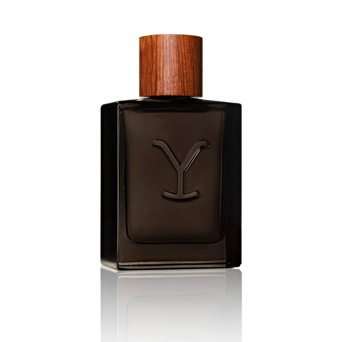 A dark brown rectangular glass perfume bottle with a wooden cap and a debossed 'Y' logo on the front, set against a clean white background with a soft reflection below.