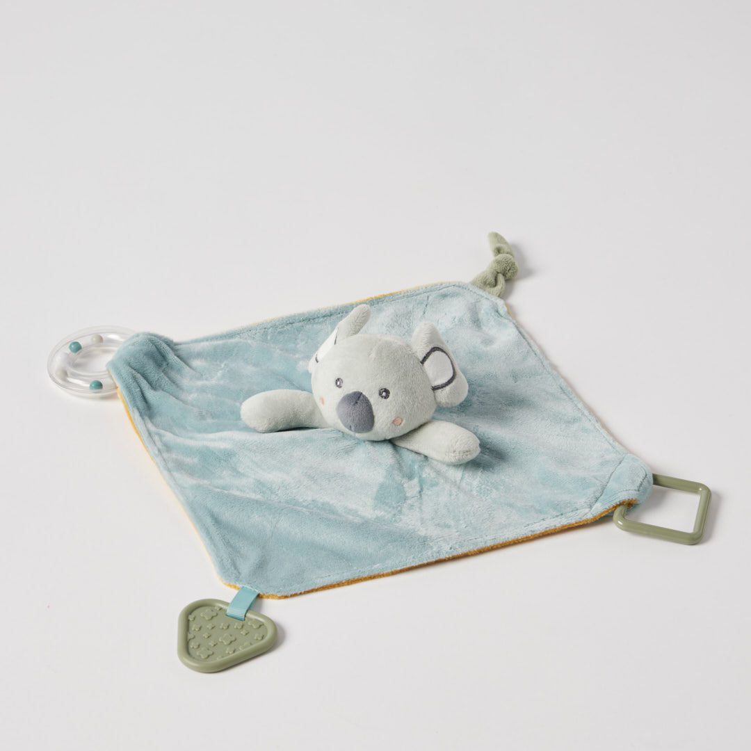 Plush toy with a blue blanket on a light gray background