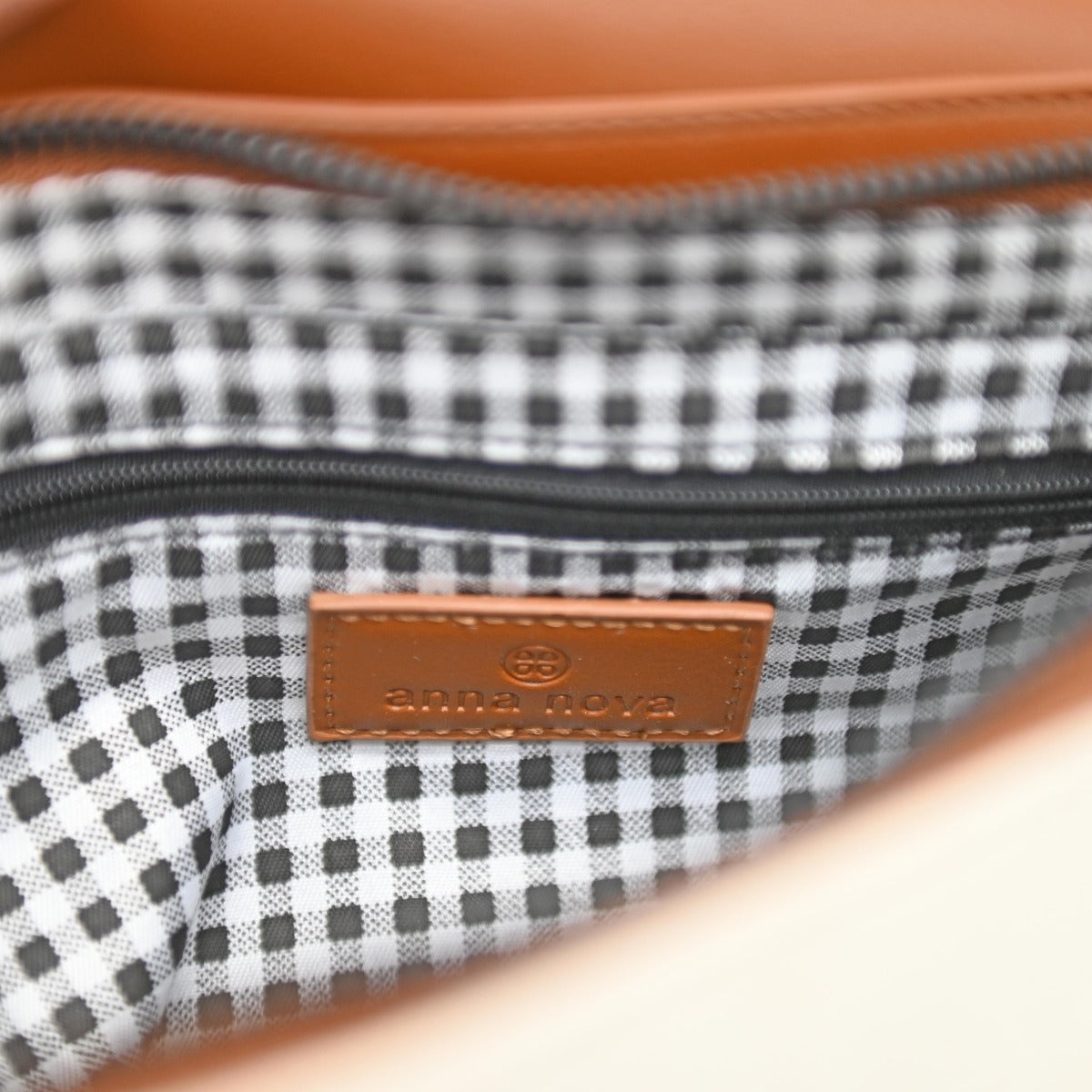 Bahamas Purse Clutch-Canvas. Close-up of a checkered pouch with a brown leather patch and visible brand logo.