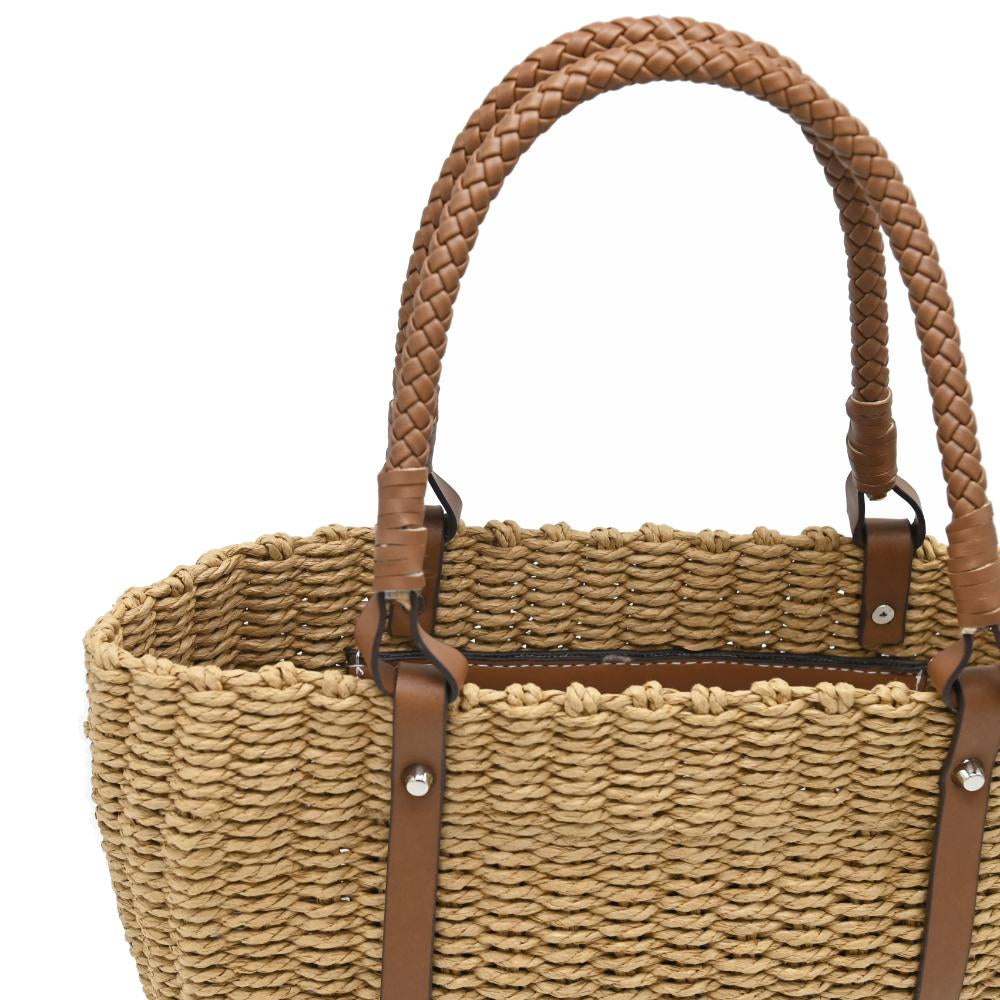 A natural woven straw tote bag with brown leather handles and side straps, shown against a plain white background.