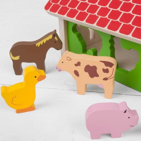 Bigjigs Toys Farmhouse Sorter. Wooden farm toy with animal figures on a white background