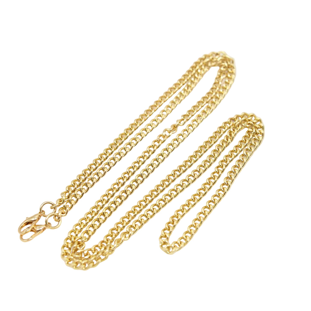 Gold chain necklace on a white surface