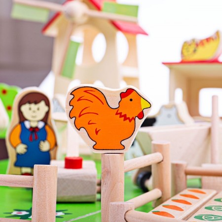 Bigjigs Toys Play Farm. Wooden farm toy set with animals and buildings on a white background