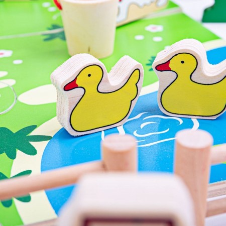 Bigjigs Toys Play Farm. Wooden duck toys on a colorful play mat with a focus on the foreground.