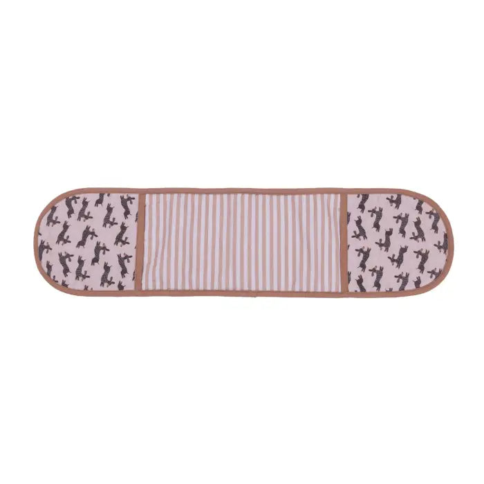 A rectangular quilted blanket or mat with rounded corners, featuring a central panel of vertical pink and white stripes, flanked by two panels with a light pink background and black dog silhouettes, finished with a brown border.