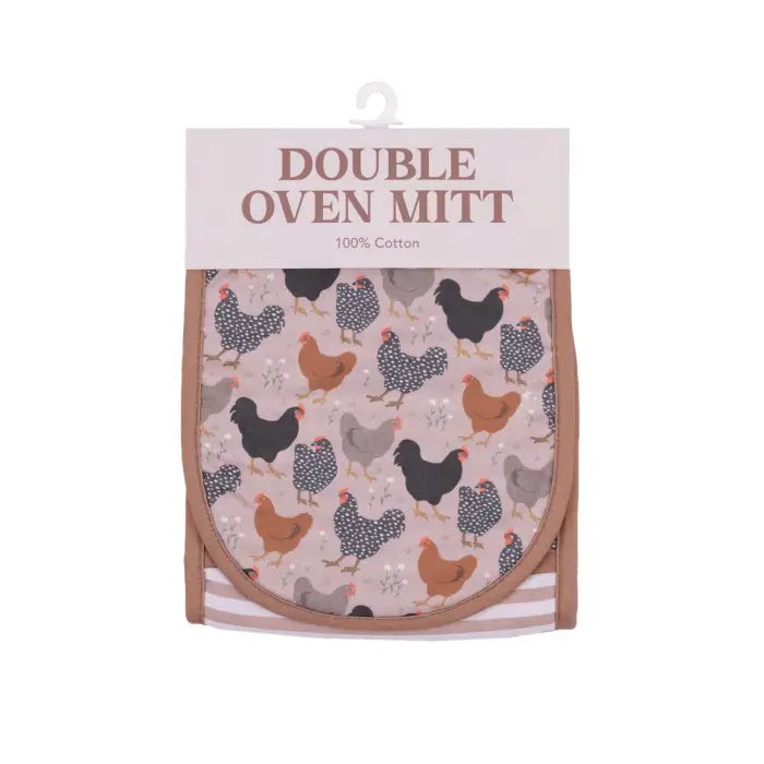 A double oven mitt in its retail packaging, featuring a chicken pattern on a dusty pink background with brown trim and a white hanger at the top.