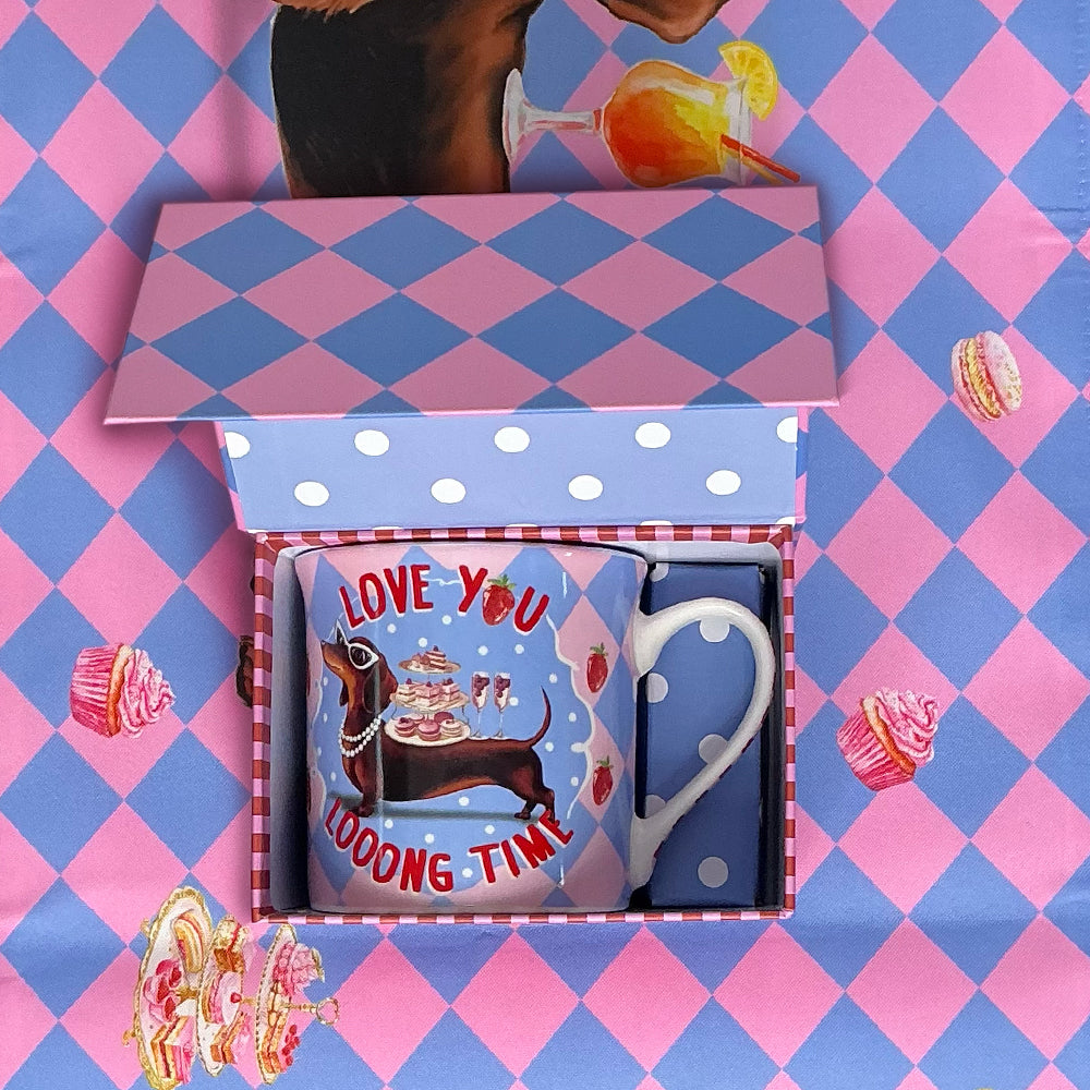 Gift set with mug and napkin in a box on a pink and blue checkered background
