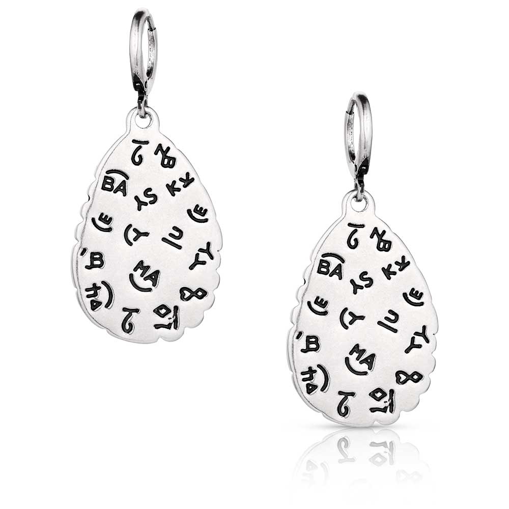 Montana Silversmith Prickly Pear Turquoise Earrings. Pair of silver earrings with engraved designs on a white background