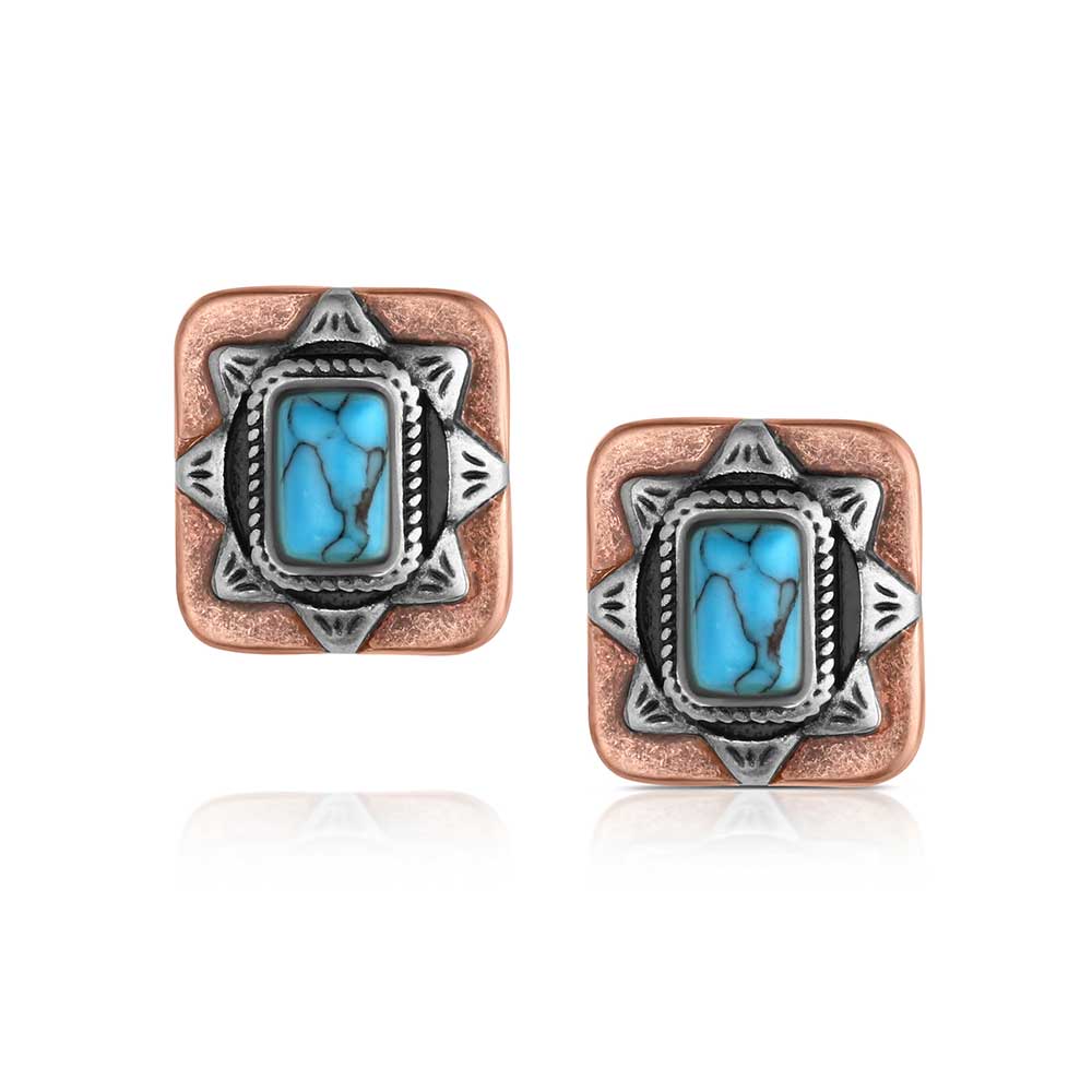Pair of square earrings with turquoise stones and copper and silver accents on a white background