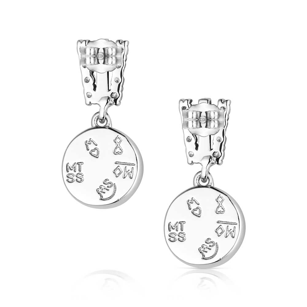 Pair of silver earrings with engraved designs on a white background