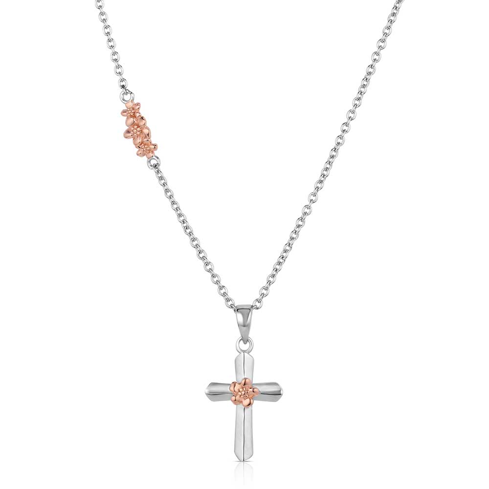 Cross pendant necklace with rose gold accents on a white background