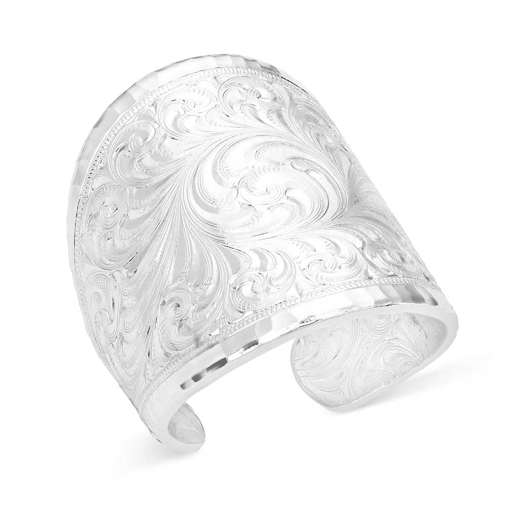 Montana Silversmith Out West Ring. Silver cuff bracelet with intricate floral patterns on a white background