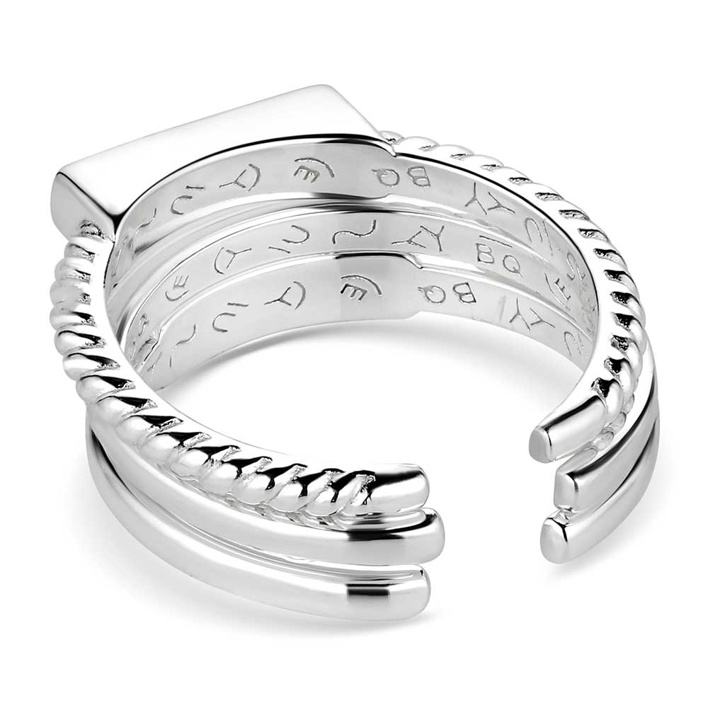 Silver ring with engraved design on a white background