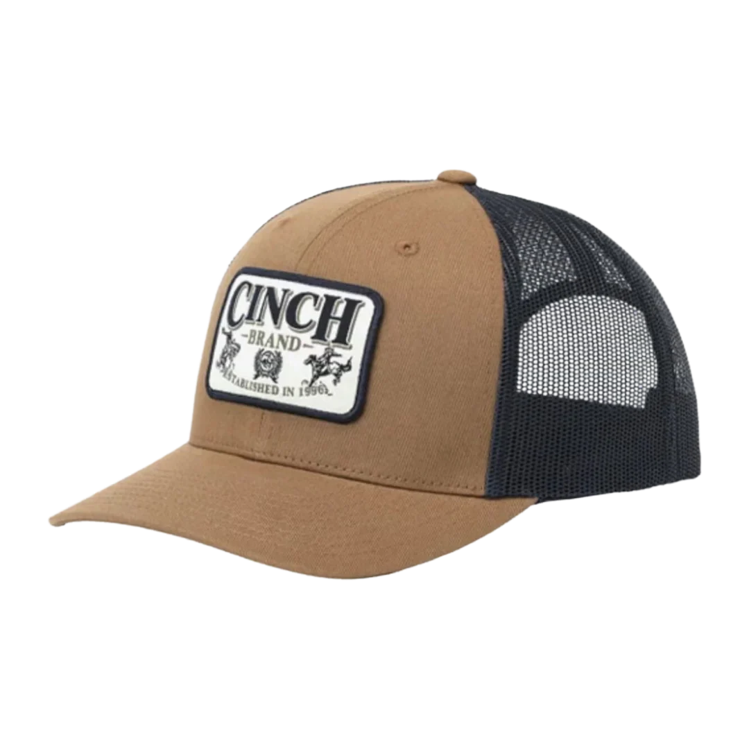 A tan and black trucker hat with a black mesh back and a front patch reading 'CINCH BRAND ESTABLISHED IN 1960'.