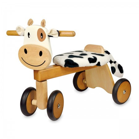 I'm Toy Paddie Rider CalfieWooden toy cow with wheels on a white background 