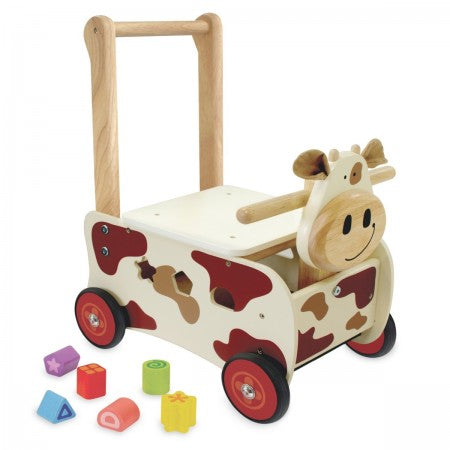 I'm Toy Walk And Ride Cow Sorter. Wooden toy cow push cart with colorful blocks on a white background